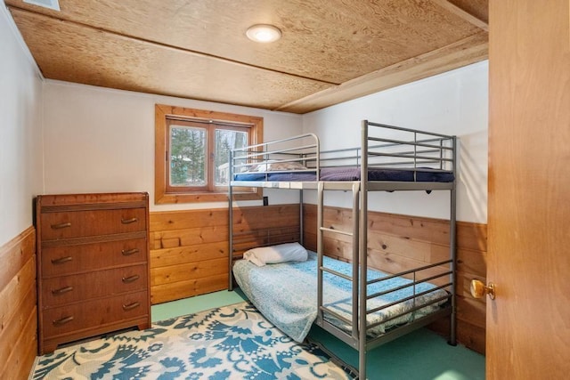 bedroom with wood walls and wood ceiling