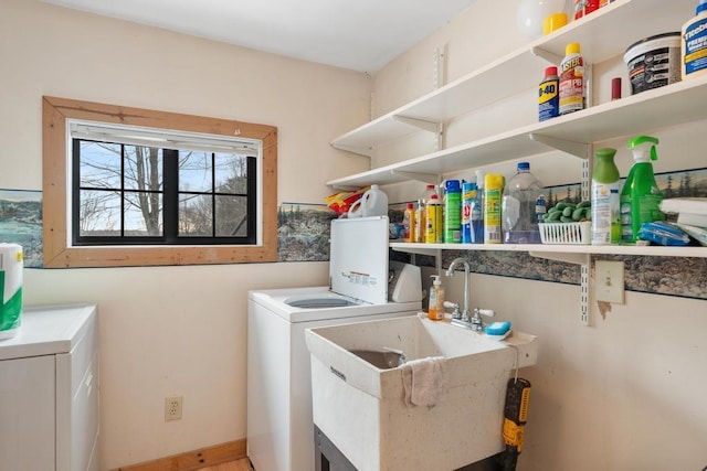 clothes washing area featuring sink and washing machine and dryer