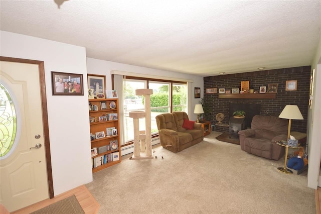 living room featuring a textured ceiling, a brick fireplace, and light carpet