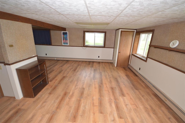 interior space featuring baseboard heating and wood-type flooring