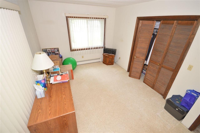 interior space featuring carpet floors and a baseboard heating unit