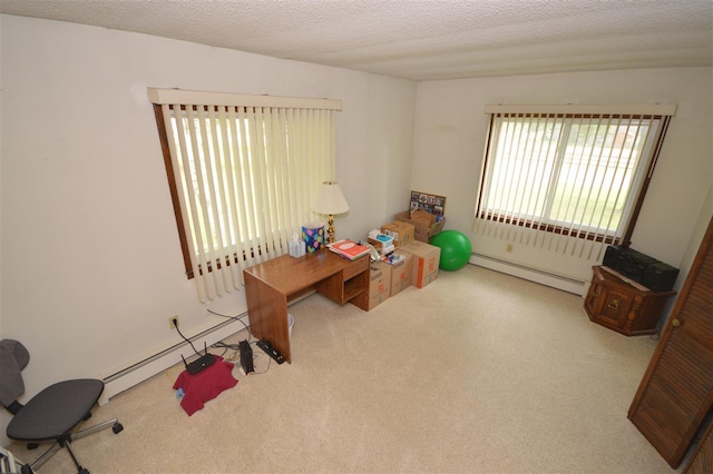 rec room with a textured ceiling, a baseboard heating unit, and carpet