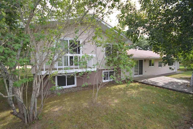 rear view of property featuring a yard