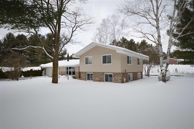 view of snow covered rear of property