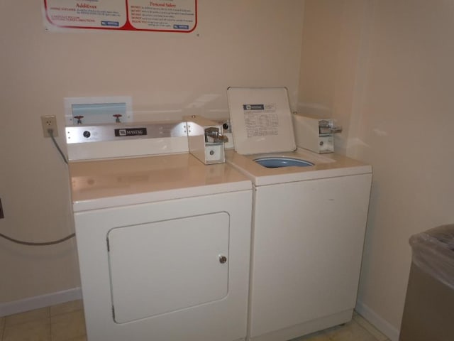 laundry area with light tile patterned floors and independent washer and dryer