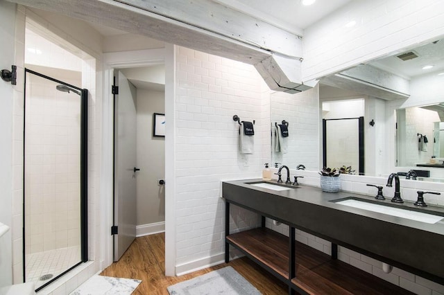 bathroom featuring vanity, hardwood / wood-style floors, and a shower with door