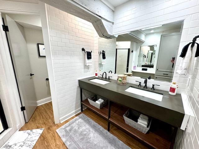 bathroom featuring vanity, a shower, and hardwood / wood-style flooring