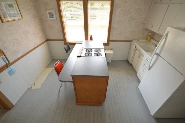 kitchen featuring sink, white appliances, and white cabinets