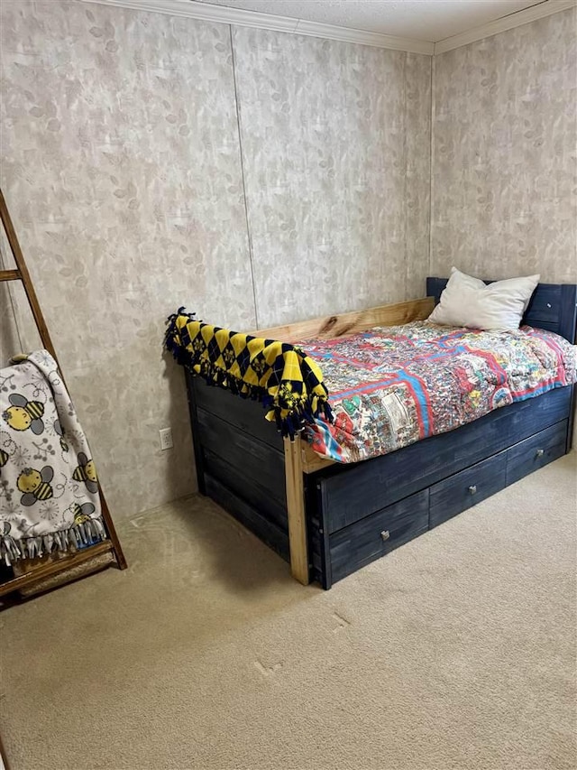 bedroom with crown molding and carpet floors