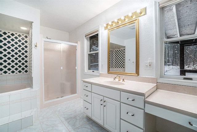 bathroom with shower with separate bathtub and vanity