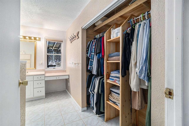 bathroom with vanity, a textured ceiling, and tile patterned flooring