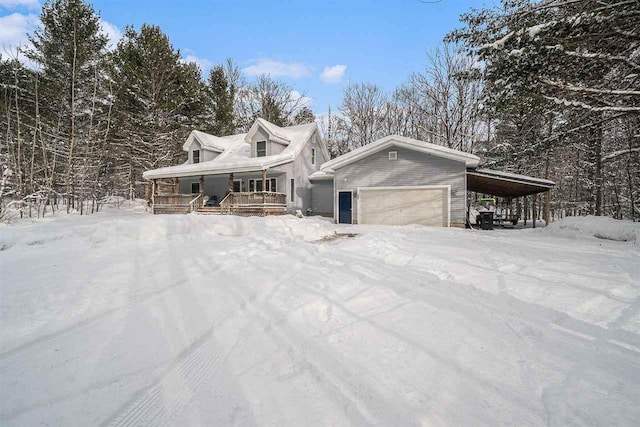 view of front of home with a carport, a porch, and a garage