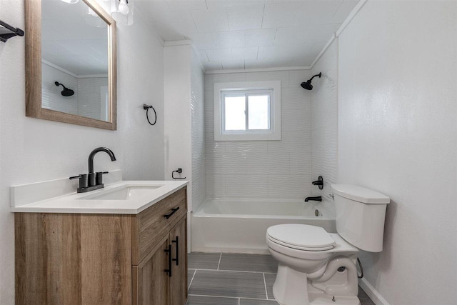 full bathroom featuring vanity, toilet, tiled shower / bath, and ornamental molding