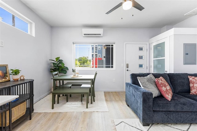 living room featuring ceiling fan, a wall mounted air conditioner, electric panel, and light wood-type flooring