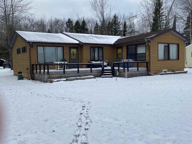 view of snow covered back of property