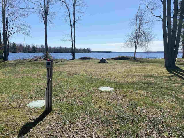 9670 Silver Strand Rd, Levering, MI 49755 - view of green lawn featuring a water view