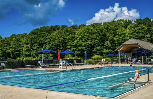 pool featuring a patio and fence