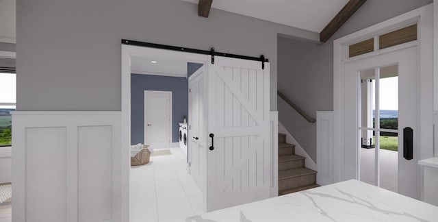 interior space featuring a barn door and vaulted ceiling with beams