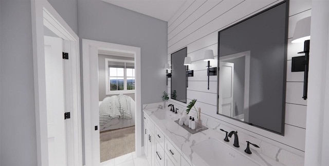 bathroom featuring vanity and wooden walls