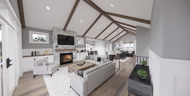 living room featuring beamed ceiling, high vaulted ceiling, a stone fireplace, and light hardwood / wood-style floors