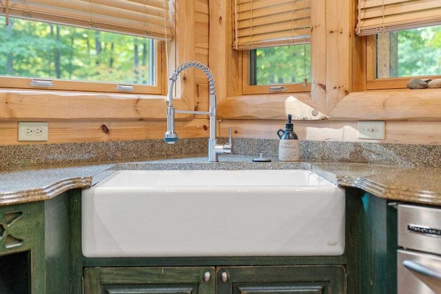 details featuring light stone countertops and sink