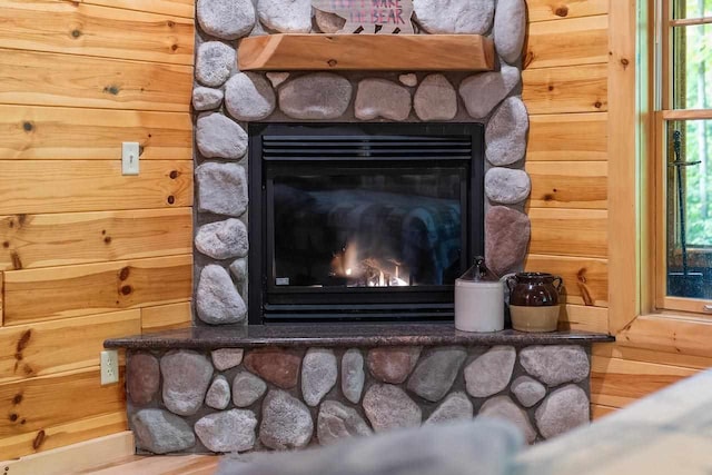 room details with wooden walls and a fireplace