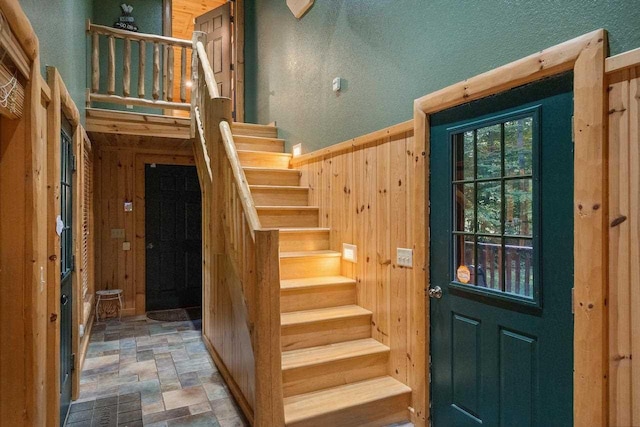 entryway featuring wooden walls