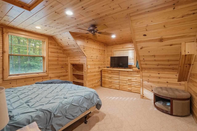 carpeted bedroom featuring wood ceiling, ceiling fan, vaulted ceiling, and wood walls