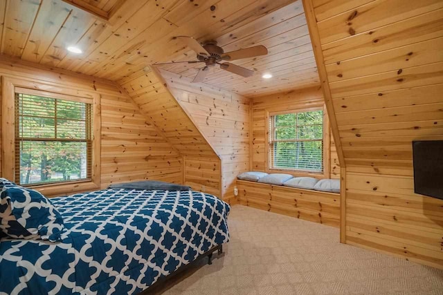 bedroom featuring ceiling fan, lofted ceiling, carpet flooring, and wood walls