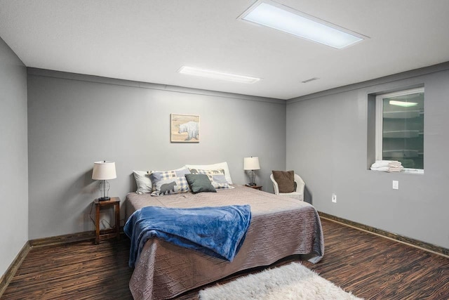 bedroom with dark wood-type flooring