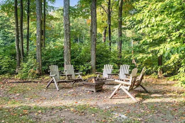 view of yard featuring an outdoor fire pit