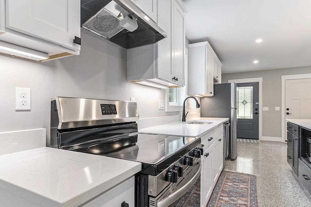 kitchen featuring white cabinetry, stainless steel electric stove, light stone countertops, and sink