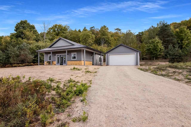 view of front of house with a garage and an outdoor structure