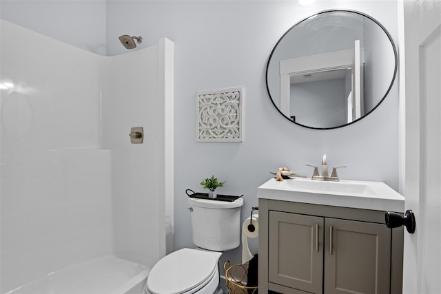 bathroom with vanity, a shower, and toilet