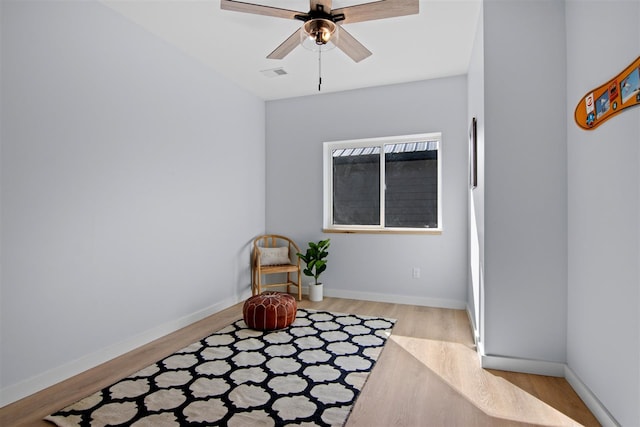 living area with ceiling fan and light wood-type flooring