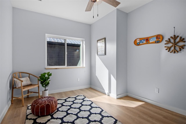 living area featuring ceiling fan and light wood-type flooring