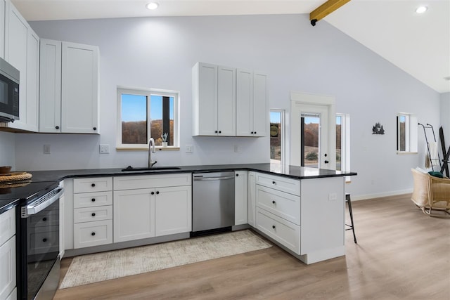 kitchen featuring stainless steel appliances, sink, and white cabinets