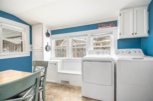 washroom with ornamental molding and washing machine and dryer