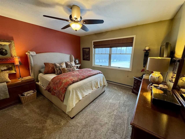 carpeted bedroom with ceiling fan and a baseboard heating unit