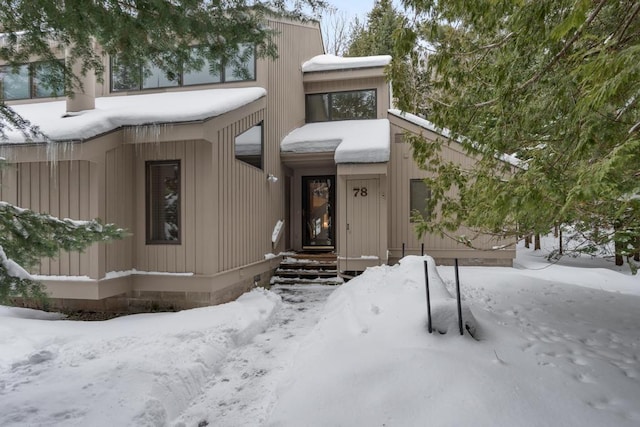 view of snow covered property entrance