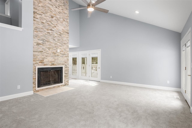 unfurnished living room featuring ceiling fan, lofted ceiling, light colored carpet, and a fireplace