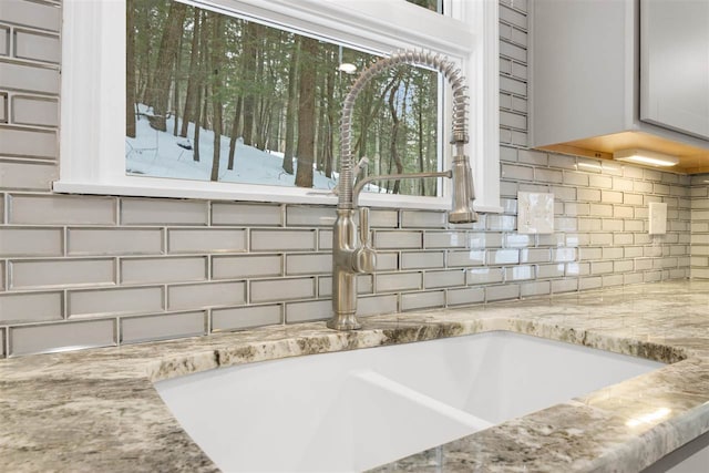 room details featuring sink and backsplash