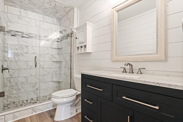 bathroom with vanity, wood-type flooring, toilet, and walk in shower