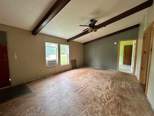 empty room featuring ceiling fan, vaulted ceiling with beams, cooling unit, and a textured ceiling