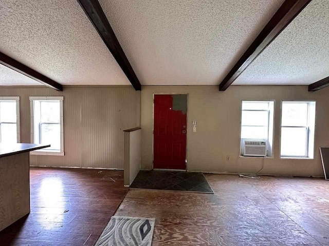 entryway featuring beamed ceiling, a textured ceiling, cooling unit, and hardwood / wood-style flooring