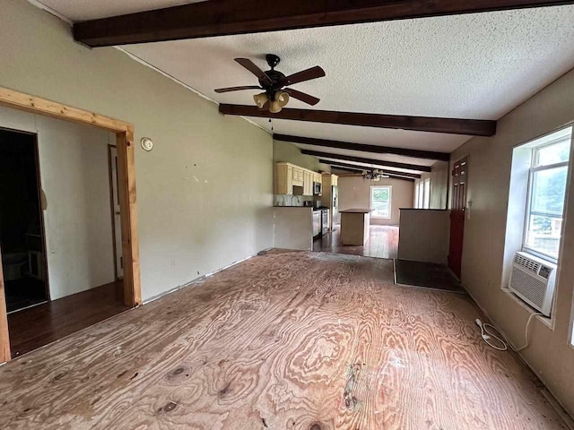 spare room with cooling unit, beam ceiling, ceiling fan with notable chandelier, and a textured ceiling