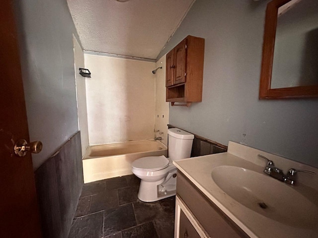 full bathroom featuring vanity, toilet, shower / bathtub combination, and a textured ceiling