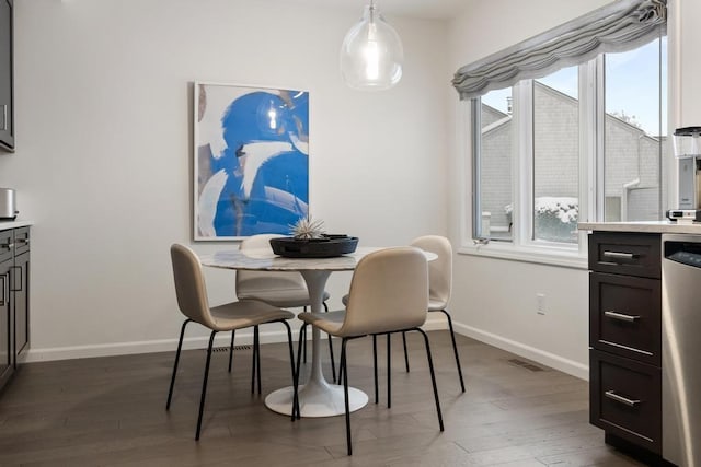 dining room with dark hardwood / wood-style flooring