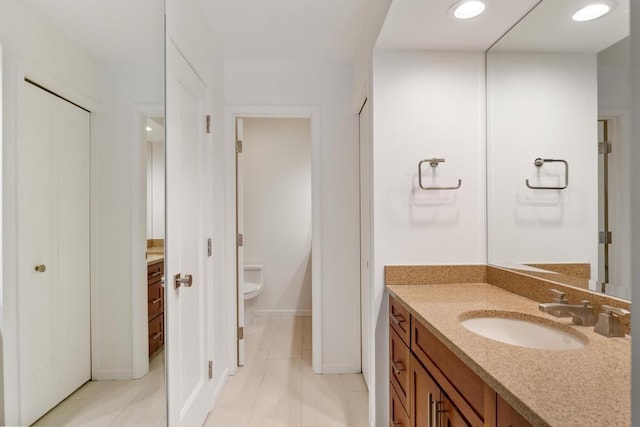 bathroom featuring tile patterned floors, vanity, and toilet