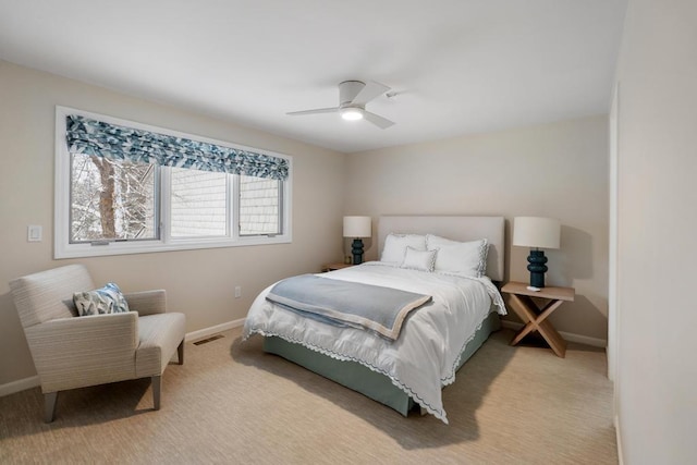 bedroom featuring light carpet and ceiling fan